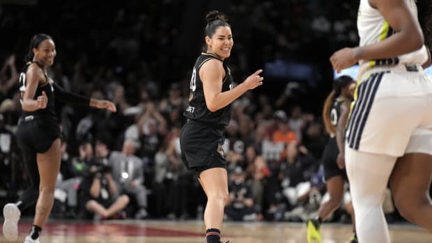 Las Vegas Aces guard Kelsey Plum smiles after a play.